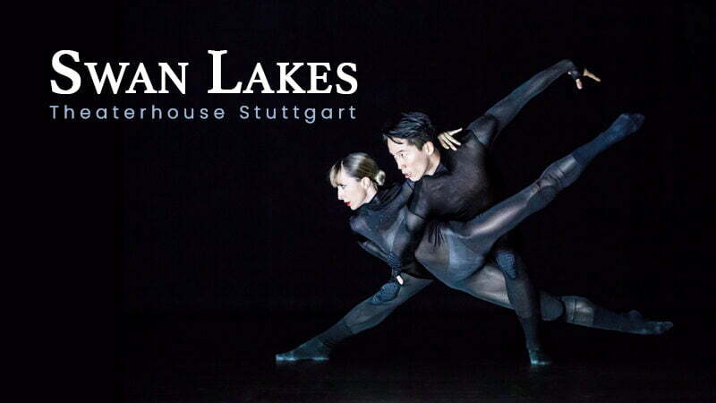 A female and male ballet dancers pose dramatically in black unitards for Theaterhouse Stuttgart's Swan Lakes